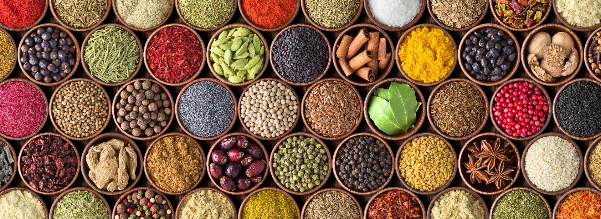 Different seasonings in cups. Spice background on the table